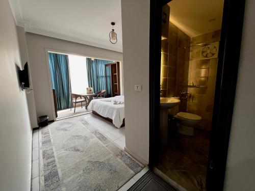 a bedroom with a bed and a bathroom with a toilet at New pyramids way in Cairo