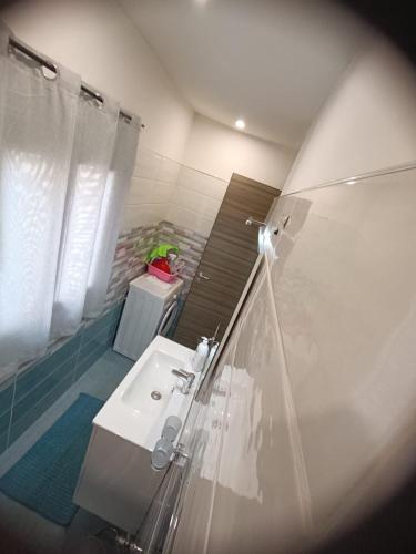 a bathroom with a sink and a shower at La Maison in Montallegro