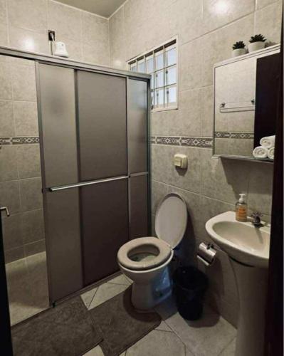 a bathroom with a toilet and a sink at Hostel Londrina in Londrina