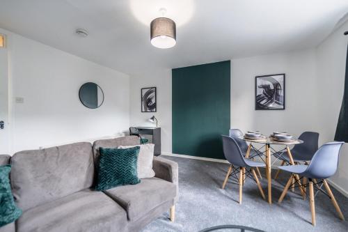 a living room with a couch and a table at Fraserburgh Apartment - 2 bed, free parking & wifi in Fraserburgh