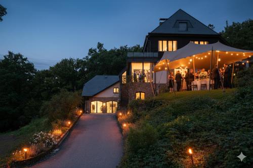 a group of people standing outside of a building at Homestorys Nature Resort in Eupen
