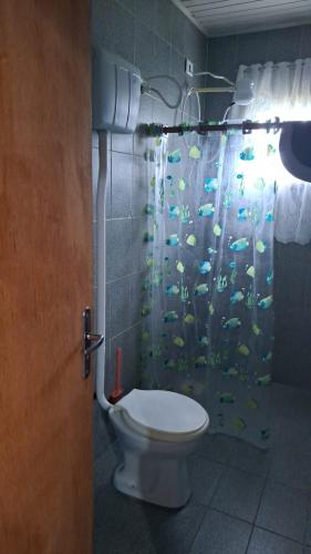 a bathroom with a toilet and a shower curtain with fish at Giuseppe & Giuseppin in Torres