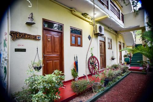 a building with a bunch of plants in front of it at Hotel Finlanka in Hikkaduwa