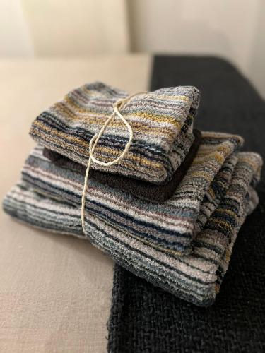 two stacks of towels sitting on a table at Van de Gruiterwonen in Axel