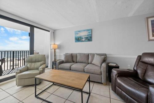 a living room with a couch and a table at Island Sunrise 362 by Youngs Suncoast in Gulf Shores