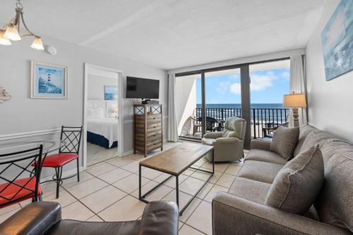 a living room with a couch and a room with a view at Island Sunrise 362 by Youngs Suncoast in Gulf Shores