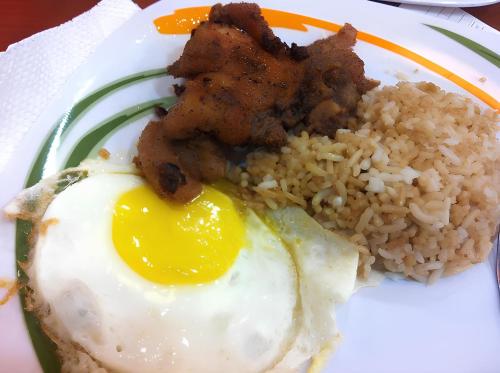 a plate of food with fried eggs and rice at Cheapest Staycation at the Metro in Manila