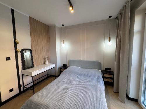 Ένα ή περισσότερα κρεβάτια σε δωμάτιο στο Apartament Wileńska