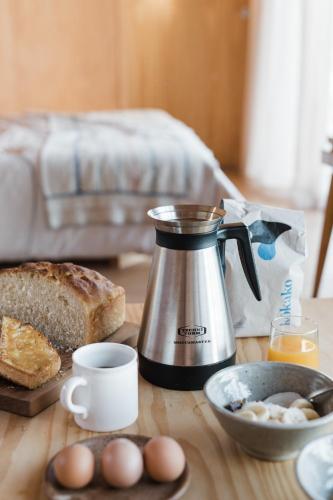 The Huts في اهيبارا: آلة صنع القهوة موضوعة على طاولة مع الخبز والبيض