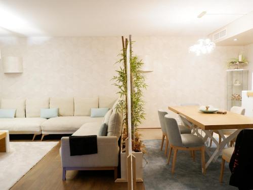 a living room with a couch and a table at Luxury 2BR Spacious & Stylish with Patio near Metro in Odivelas