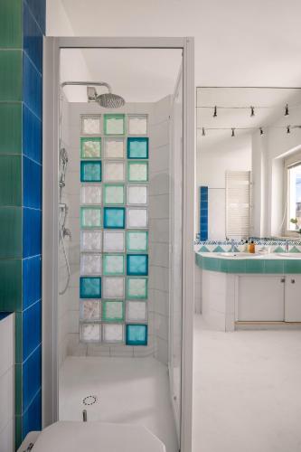 a bathroom with a shower with blue and white tiles at Villa Rosaria in Giarre
