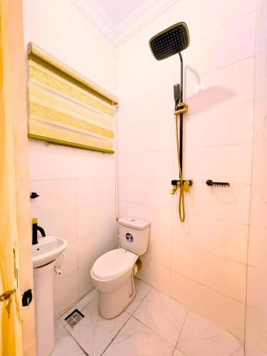 a bathroom with a toilet and a speaker in it at B&L Apartments in Port Harcourt