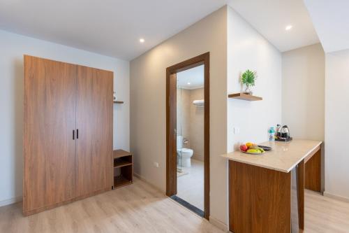 a bathroom with a counter and a wooden cabinet at Seven Stays New Cairo in Cairo