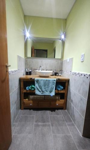 a bathroom with a sink and a mirror at Cabaña Cina Cina in Villa Larca