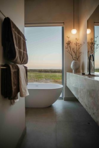 a bathroom with a bath tub and a window at Box Hill Esperance in Esperance