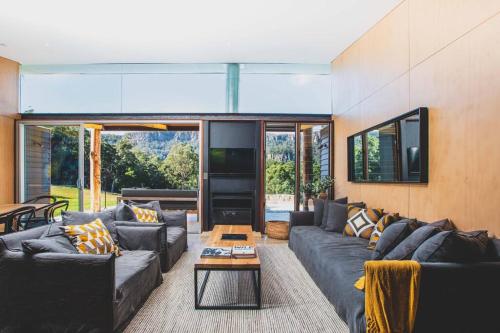 a living room with couches and a table at Willow at Barranca - Luxury Villa in Barrengarry