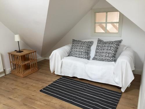 a white couch with pillows in a living room at Casa Ceol in Ennis