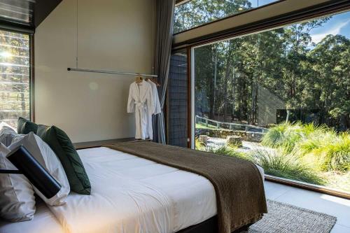 a bedroom with a bed and a large window at Ferndale at Barranca - Luxury Villa in Barrengarry