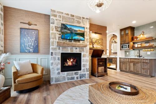 a large living room with a stone fireplace at The Oak Room - Newly Built 2B2B Loft Near Park City in Midway