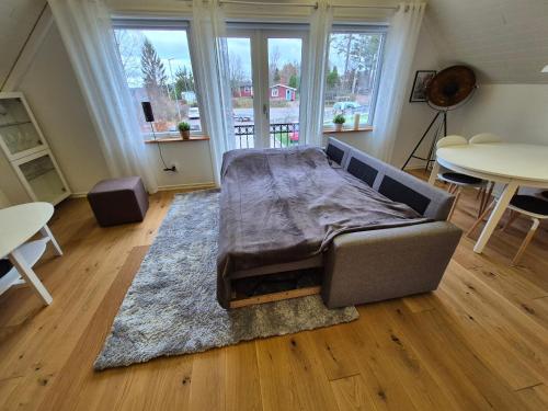 a couch with a blanket on it in a living room at Toftahöjden 7 in Växjö