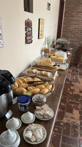 a buffet with many different types of bread and pastries at Pousada Tapajos Bonito in Bonito