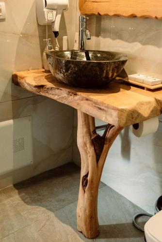 a wooden counter with a sink on top of it at Alpeta Agrotourism & Winery - Roshnik , Berat in Berat