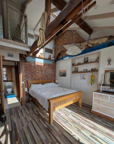 a bedroom with a large bed in a room at Cowes View Seaside beach cottage, in Hill Head