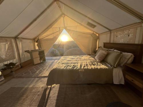 a bedroom with a bed in a tent at A Cozy Sunrise Glamping Escape with Panoramic View in Fallbrook