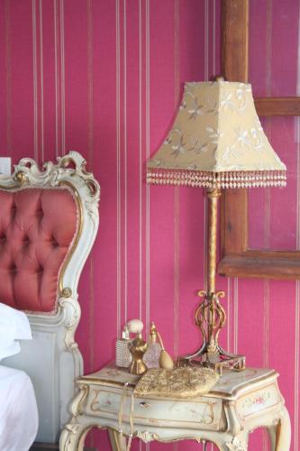 a lamp on a table next to a bed at Lokanga Boutique Hotel in Antananarivo