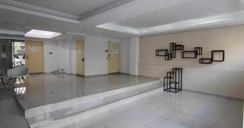 a large room with a lobby with a table and chairs at LoftPoint Rosario, Pileta, Solarium y Terraza con vista al Río in Rosario