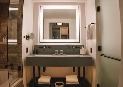 a bathroom with a sink and a mirror at Limelight Boulder in Boulder