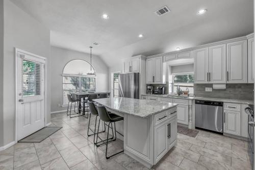 a large kitchen with white cabinets and a counter top at Aspen Drive in Montgomery