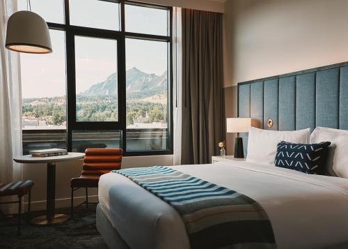 a hotel room with a bed and a desk and a window at Limelight Boulder in Boulder
