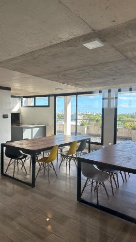 a large dining room with a large table and chairs at Bright on the avenue in Mar del Plata
