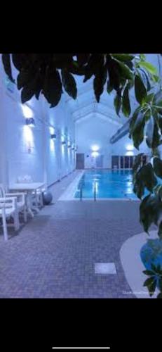 a swimming pool in a large building with a swimming pool at Seafolly Beach House The Bay Filey Step Free Accommodation Private Offstreet Parking in Filey