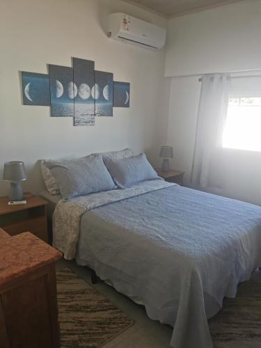 a bedroom with a bed and some pictures on the wall at La Abuelita in Rocha