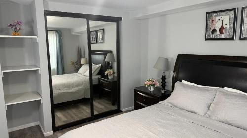 a bedroom with a bed and a large mirror at Cozy 2BR, Totally Private With Parking, Convenient Public Transit in San Francisco