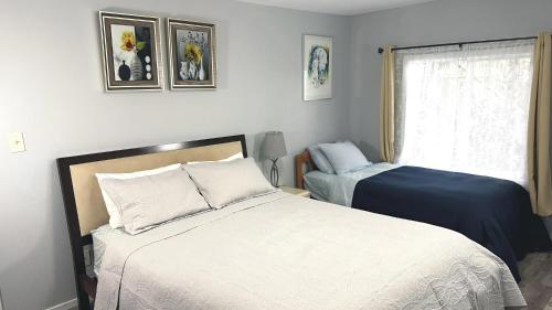 a bedroom with two beds and a window at Cozy 2BR, Totally Private With Parking, Convenient Public Transit in San Francisco