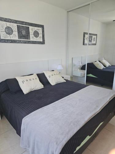 a bedroom with a large bed and a mirror at PALERMO APART 1 in Buenos Aires
