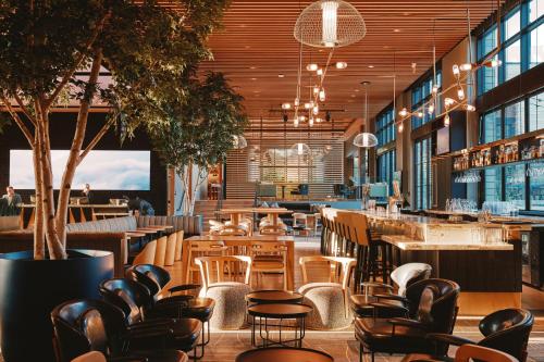 a restaurant with chairs and tables and a bar at Limelight Boulder in Boulder