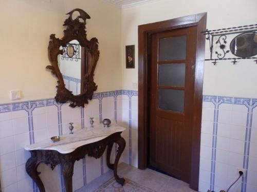 a bathroom with a sink and a mirror on the wall at Casas do Durão-Memories House in Lajeosa