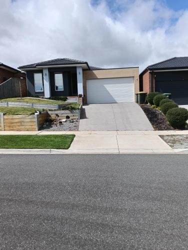 a house with a driveway and a garage at Bay View's in Clifton Springs