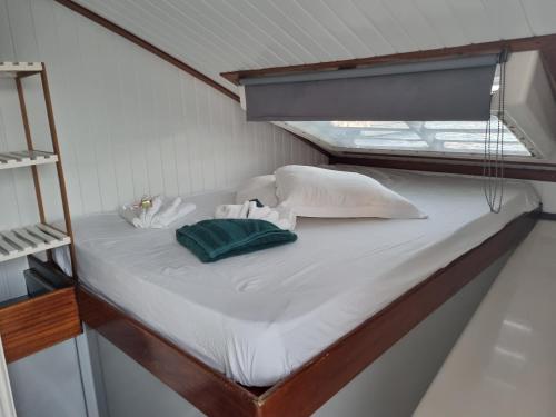 a bed in a small room with a window at catamaran nautilodge in Sainte-Anne
