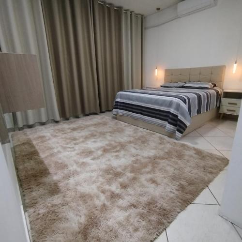 Ένα ή περισσότερα κρεβάτια σε δωμάτιο στο AP Morada das Palmeiras