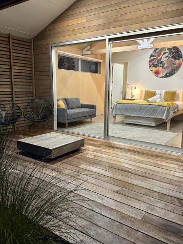 a master bedroom with a bed and a patio at One O One Cabins, Waiheke Island in Oneroa