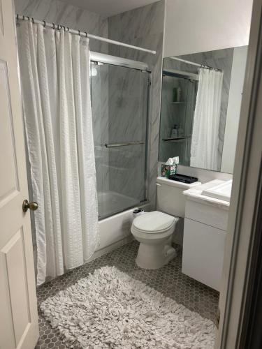 a bathroom with a shower and a toilet and a sink at Beautiful 2 Bedroom 2 Bathroom Condo in Naples