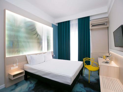 Postel nebo postele na pokoji v ubytování ibis Styles Dunarea Galati