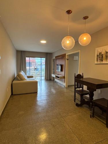 un salon avec un canapé et un piano dans l'établissement Apartamento Centro Guriri 3 Quartos, à São Mateus