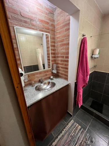 a bathroom with a sink and a mirror at Cabañas Don Lelio 2 in Mina Clavero