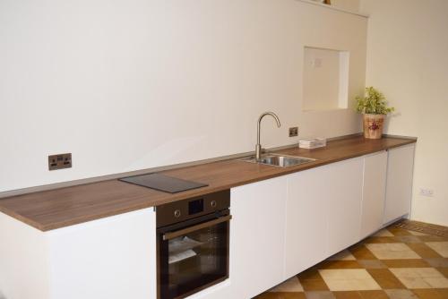 a kitchen with a sink and a counter top at Valletta Mint Apartment 1 in Valletta
